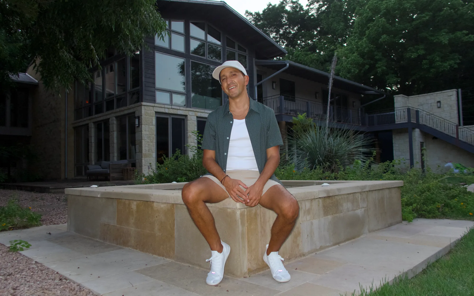 Kyle Lasota sitting outside his home at dusk